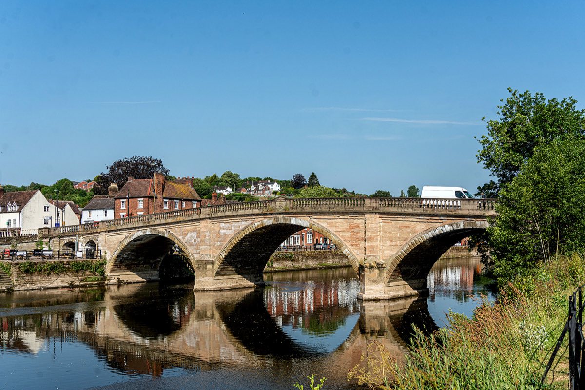 Bewdley Bridge over the River Severn, with riverside trees and the town's houses beyond